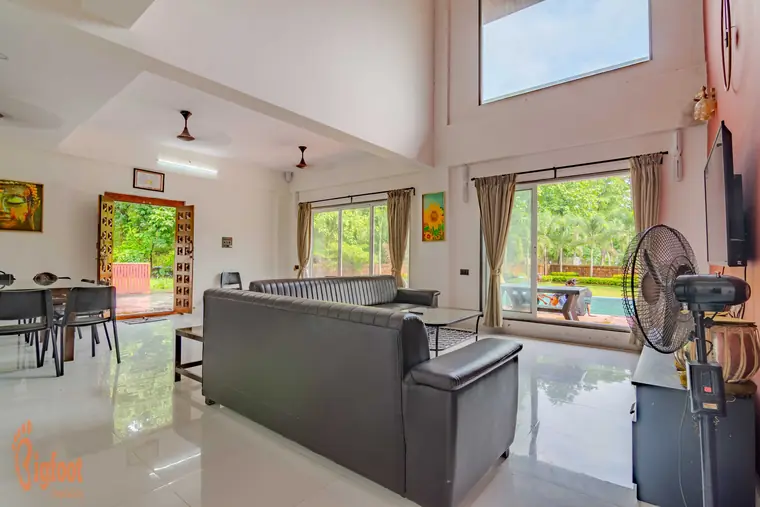 Double-height living hall at Hideaway Villa with a terracotta feature wall