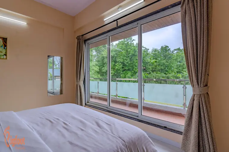 Bedroom at Hideaway Villa opening onto the shared balcony