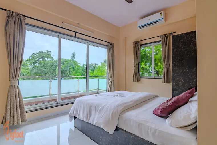 Bright bedroom at Hideaway Villa with twin windows